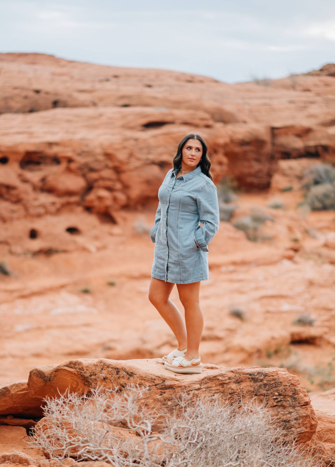 A family portrait standing among red rock formations