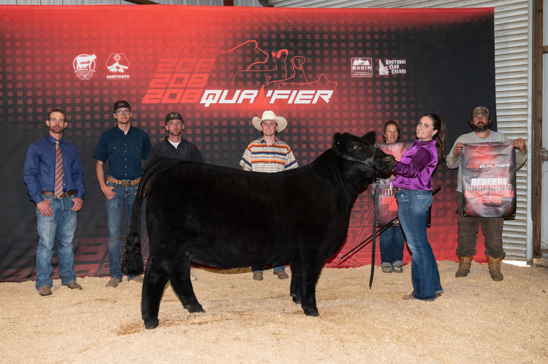 The show team lined up behind the Reserve Champion Maine-Anjou heifer at the 208 Qualifier
