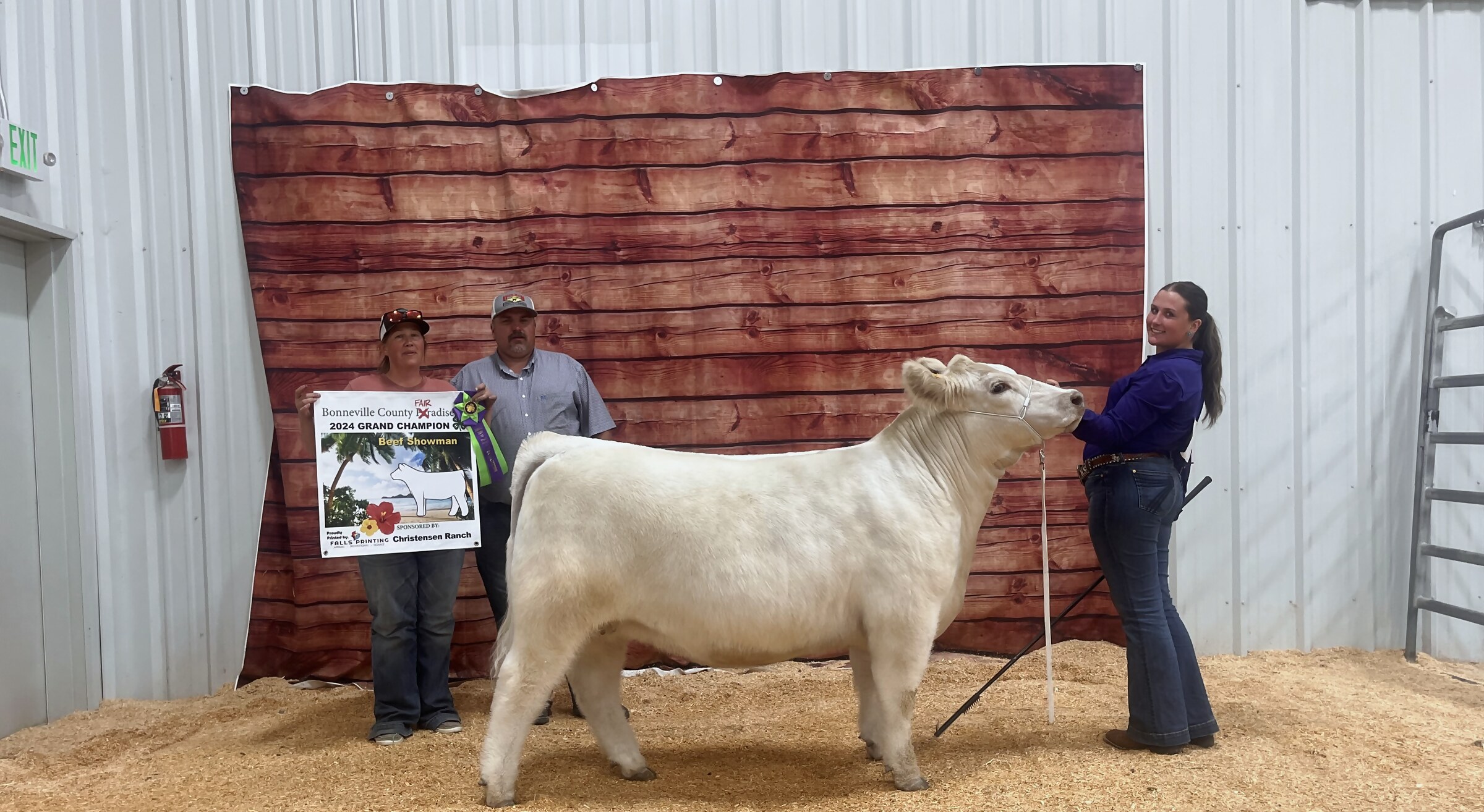 Kadence with her cream show heifer beside the Bonneville County Fair 2024 Grand Champion Beef Showman placard