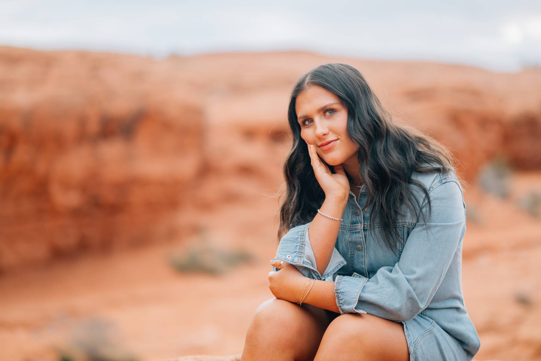 A seated portrait against the red rock landscape
