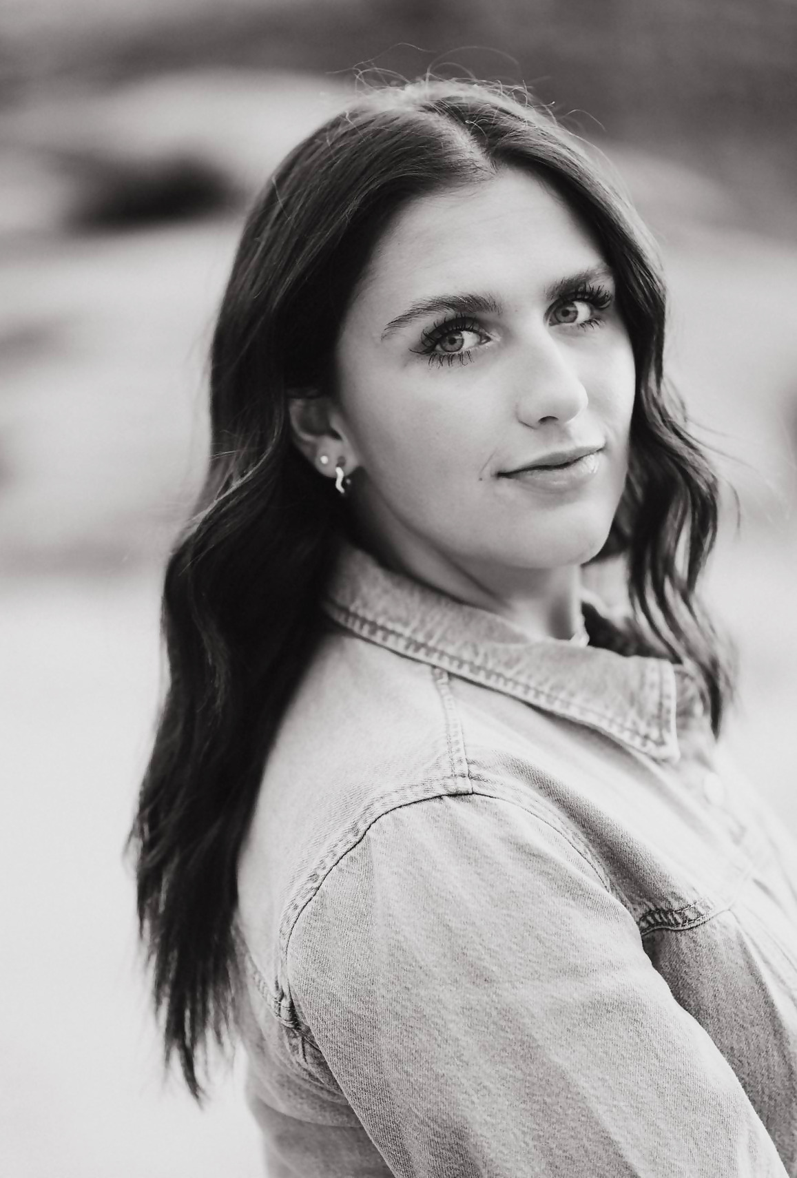 Black-and-white portrait of Kadence looking back over her shoulder